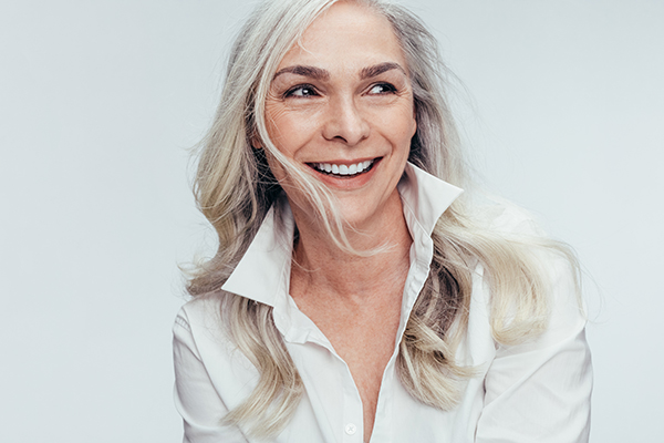 A woman with short hair is smiling at the camera.